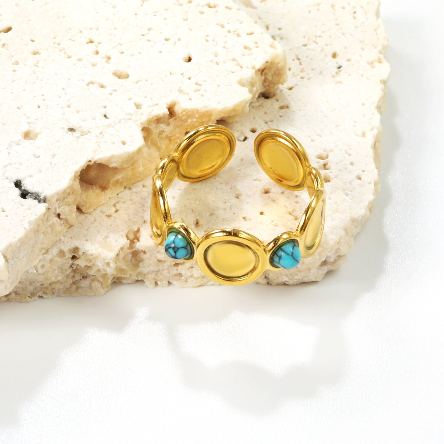 The ring consists of discs of various sizes and is set with 2 turquoise stones. asonjewelry