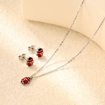 Seven star ladybug set Steel color/golden earrings: 7.3*8.2mm Pendant: 7.3*8.8mm0.3 Cross chain 40+5cm+6mm round plate asonjewelry