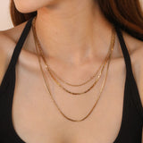 Three-tier combination necklace with distinct styles, gold