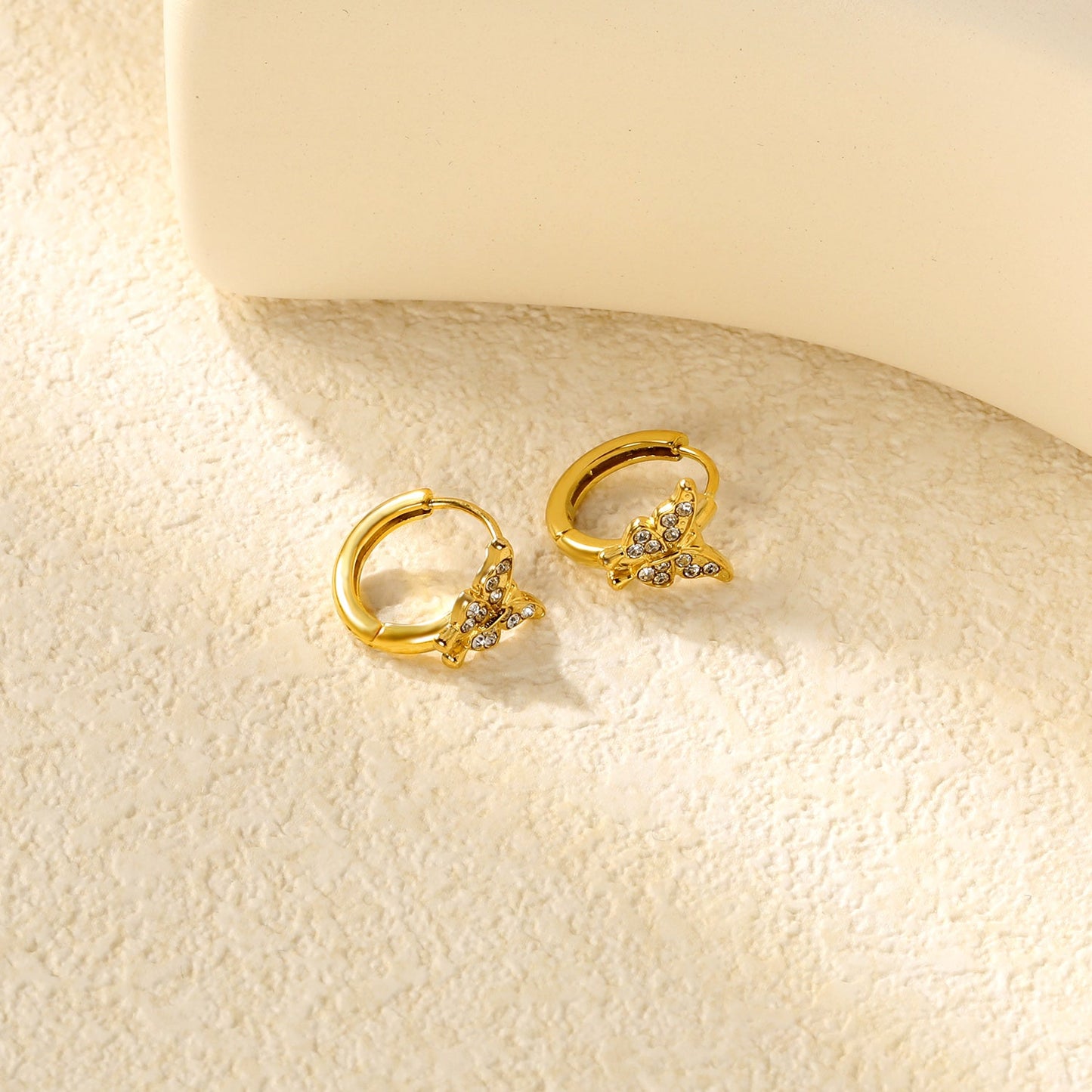 10.3 x 8.8mm butterfly-shaped white zirconia earring with a 2.2mm earring post and a 10mm inner diameter, gold-colored asonjewelry