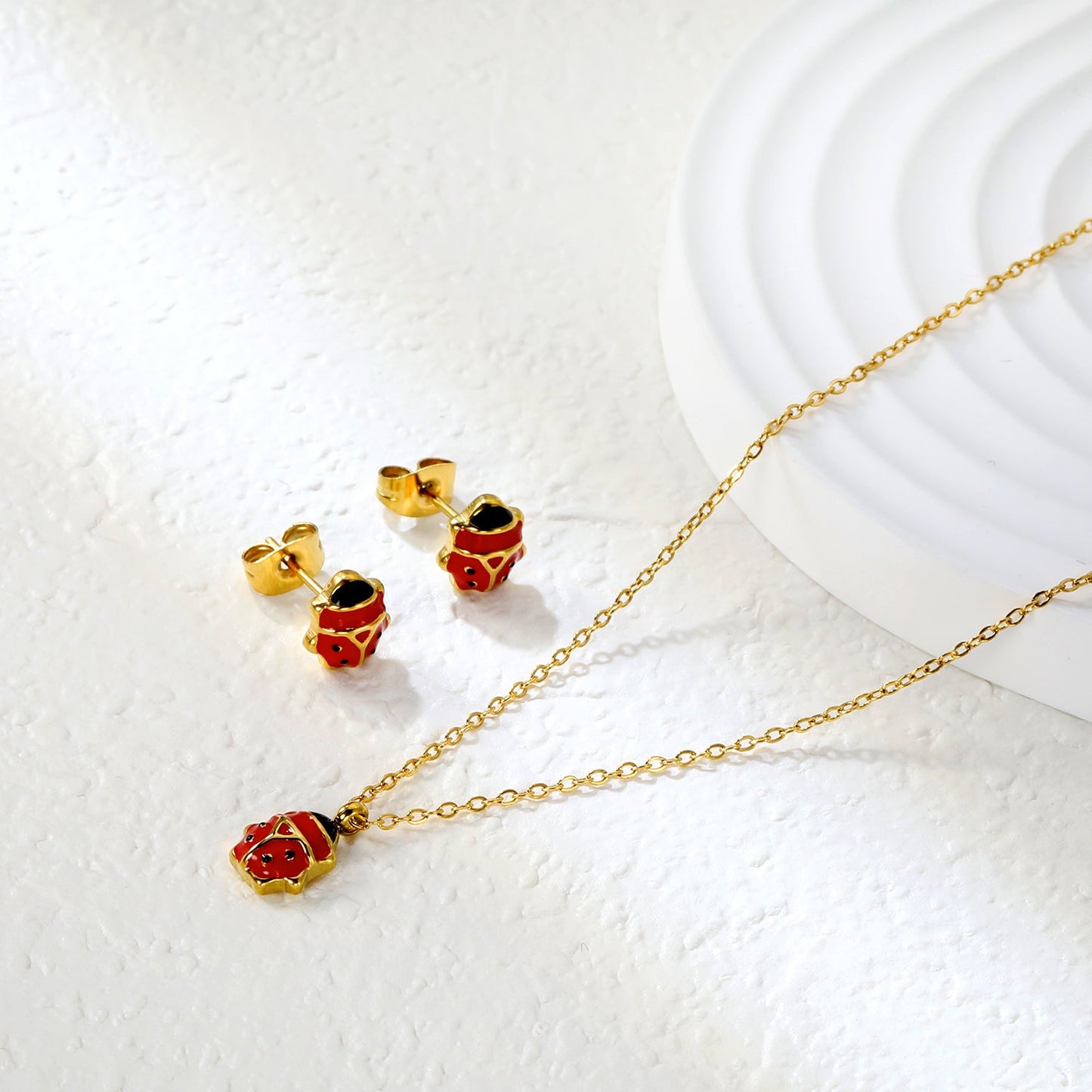 Seven star ladybug set Steel color/golden earrings: 7.3*8.2mm Pendant: 7.3*8.8mm0.3 Cross chain 40+5cm+6mm round plate asonjewelry