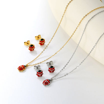 Seven star ladybug set Steel color/golden earrings: 7.3*8.2mm Pendant: 7.3*8.8mm0.3 Cross chain 40+5cm+6mm round plate asonjewelry