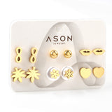 Six pairs of mixed card mounted cut glossy lips / maple leaf stud earrings gold color