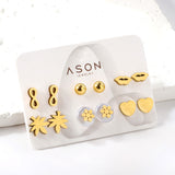 Six pairs of mixed card mounted cut glossy lips / maple leaf stud earrings gold color