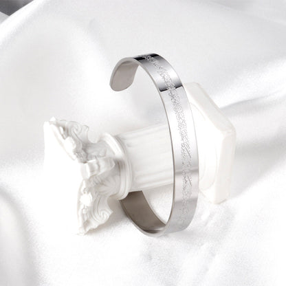 Extra wide hard open bangle in steel color with engraved surface asonjewelry