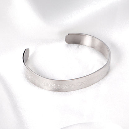 Extra wide hard open bangle in steel color with engraved surface asonjewelry