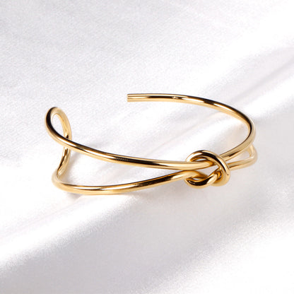 Hard bangle with minimalist clasp shape in gold color asonjewelry