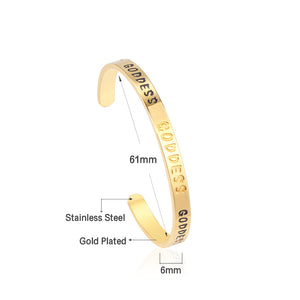 Gold colored hard bracelet with GODDESS printed on it