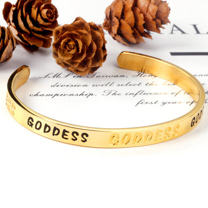 Gold colored hard bracelet with GODDESS printed on it asonjewelry