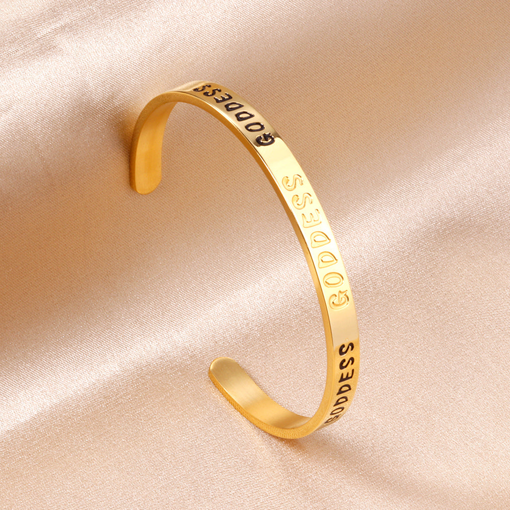 Gold colored hard bracelet with GODDESS printed on it asonjewelry
