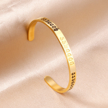 Gold colored hard bracelet with GODDESS printed on it asonjewelry