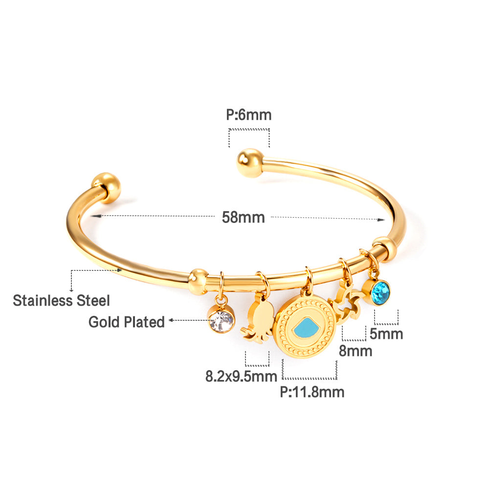 Gold bangle with two diamonds of different colors and a charm with a scallop on the door of the discus. asonjewelry