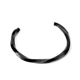 Three colors of black gold-tone steel with a rotating surface on an open-end rigid bracelet.