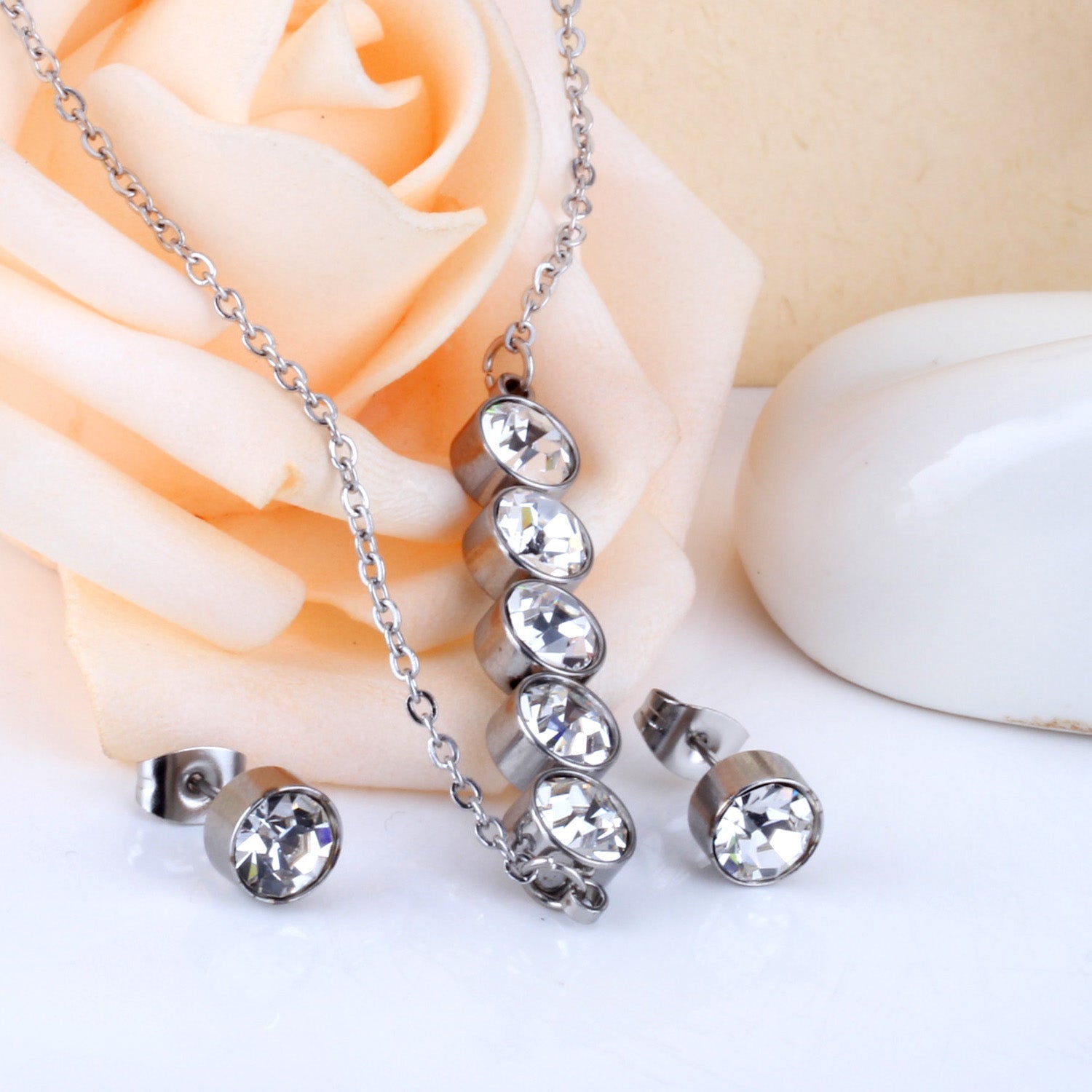 Gold/steel five white diamonds arranged in a word jewelry set asonjewelry