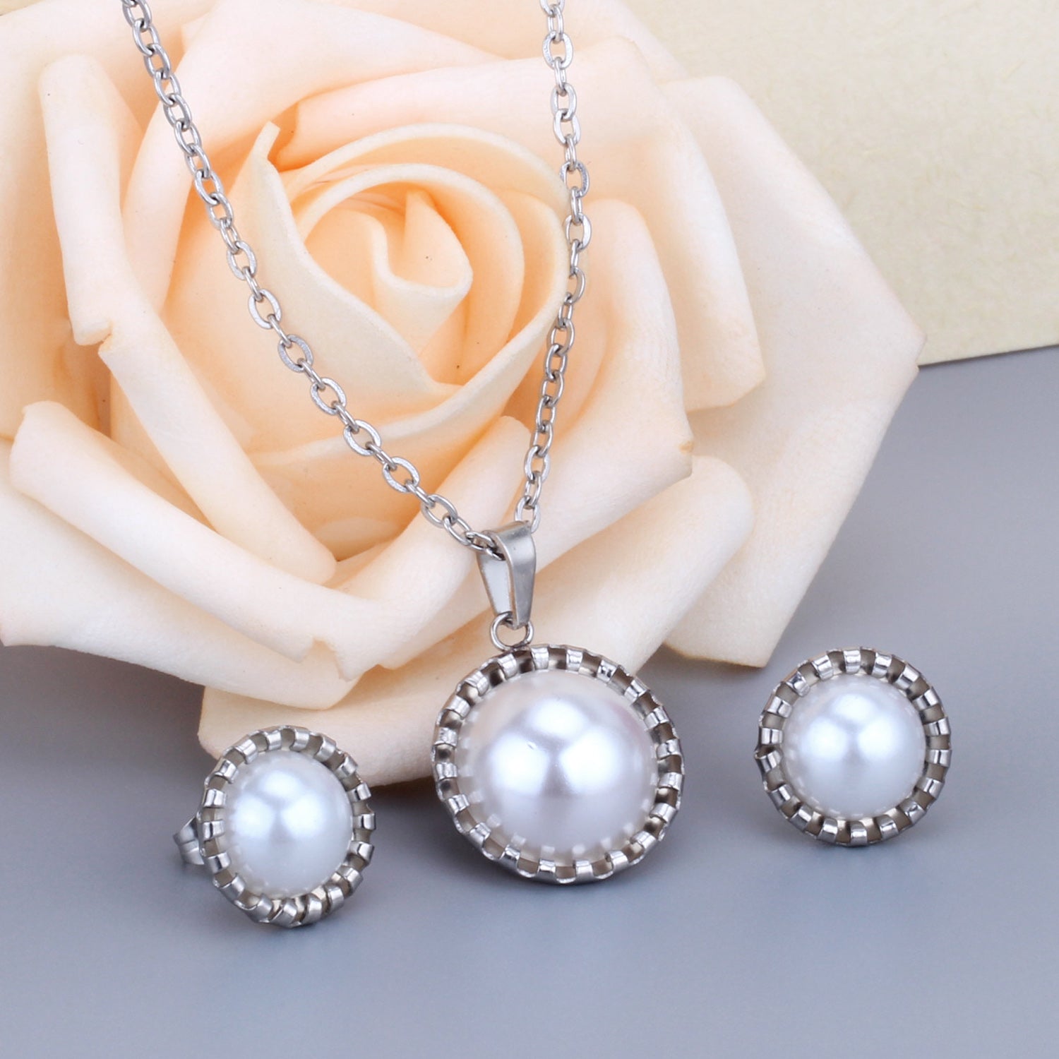 Gold/steel half pearl standing on top of round cake jewelry set asonjewelry